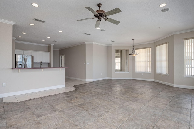 unfurnished living room featuring ceiling fan, crown molding, light tile patterned floors, and a textured ceiling