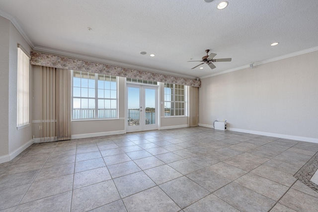 tiled spare room featuring a textured ceiling, ceiling fan, crown molding, and french doors