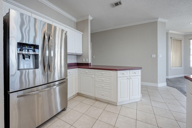 kitchen featuring white cabinetry, stainless steel refrigerator with ice dispenser, crown molding, a textured ceiling, and light tile patterned floors