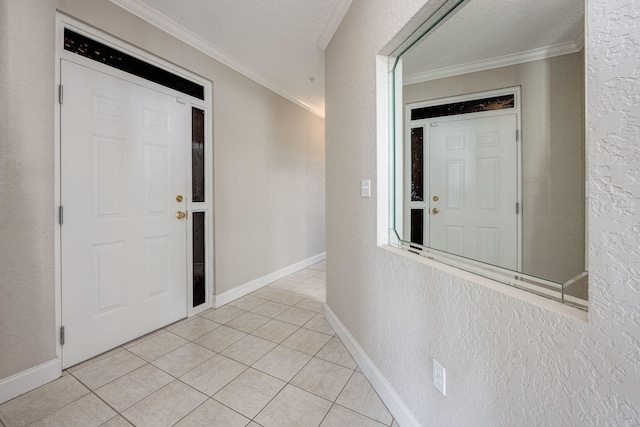 tiled entryway with ornamental molding and a textured ceiling