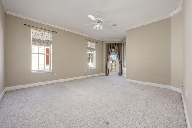 unfurnished room featuring light carpet, ceiling fan, and crown molding