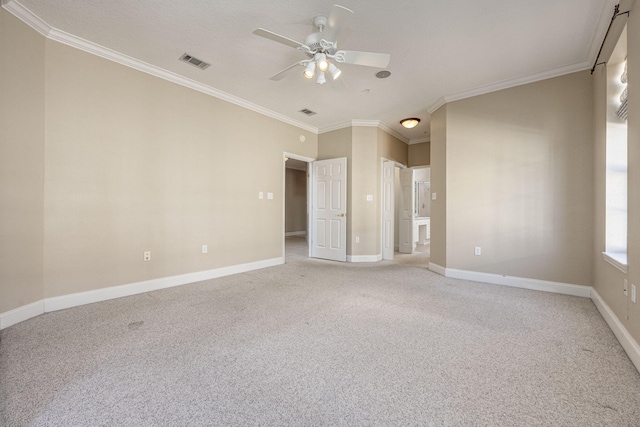 empty room with ceiling fan, crown molding, and light carpet