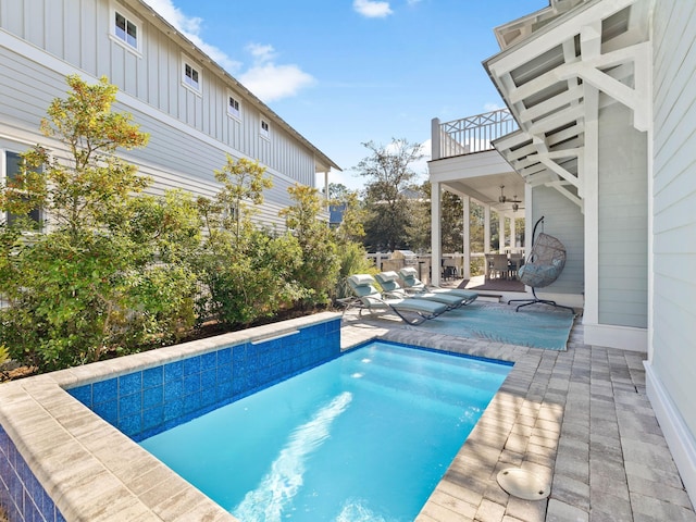 view of pool with ceiling fan and a patio area