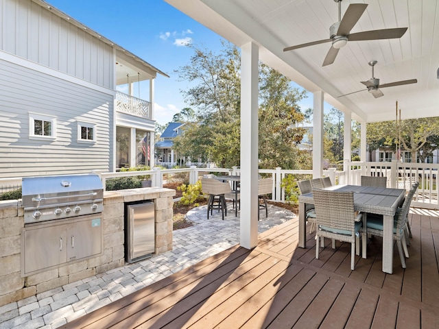 deck with area for grilling, grilling area, and ceiling fan