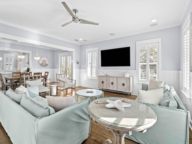 living room featuring ceiling fan, ornamental molding, and dark wood-type flooring