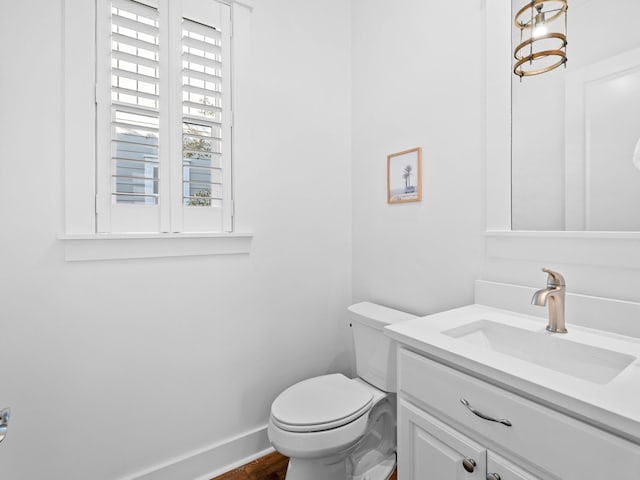 bathroom with vanity, a healthy amount of sunlight, and toilet