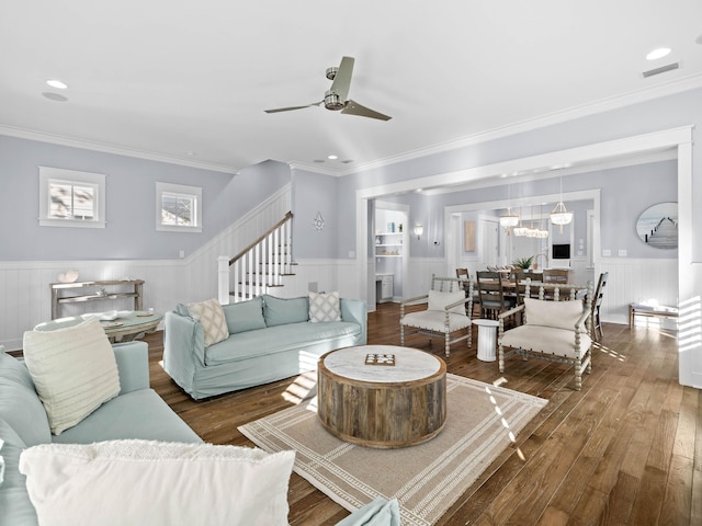 living room with dark hardwood / wood-style flooring, ceiling fan, and ornamental molding