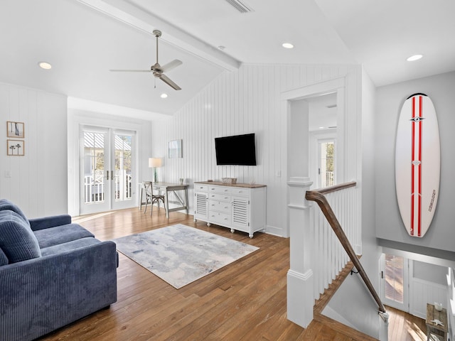 living room with lofted ceiling with beams, ceiling fan, hardwood / wood-style floors, and a healthy amount of sunlight