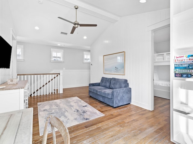 living room with vaulted ceiling with beams, light wood-type flooring, and ceiling fan