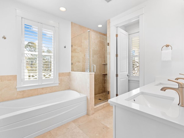 bathroom with tile patterned floors, vanity, and separate shower and tub