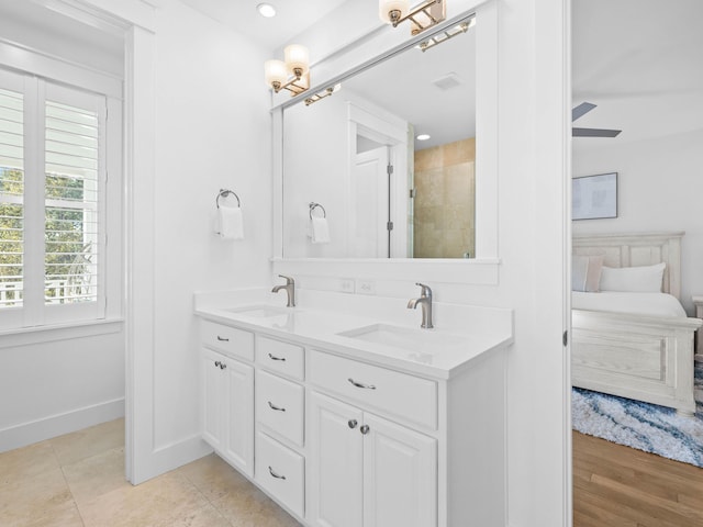 bathroom with tile patterned flooring, vanity, and ceiling fan