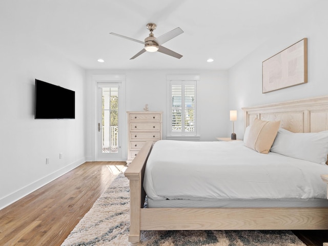 bedroom with ceiling fan, wood-type flooring, and access to outside