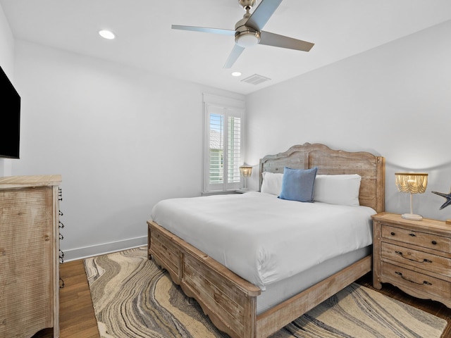 bedroom with ceiling fan and wood-type flooring