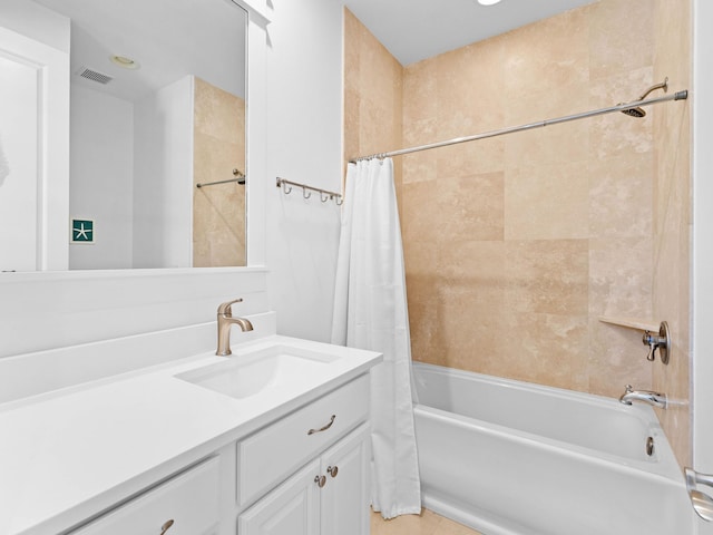 bathroom featuring vanity and shower / tub combo with curtain