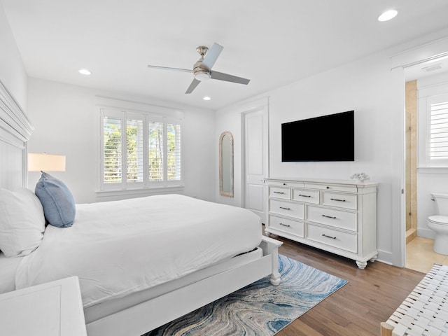 bedroom featuring ensuite bathroom, ceiling fan, and wood-type flooring