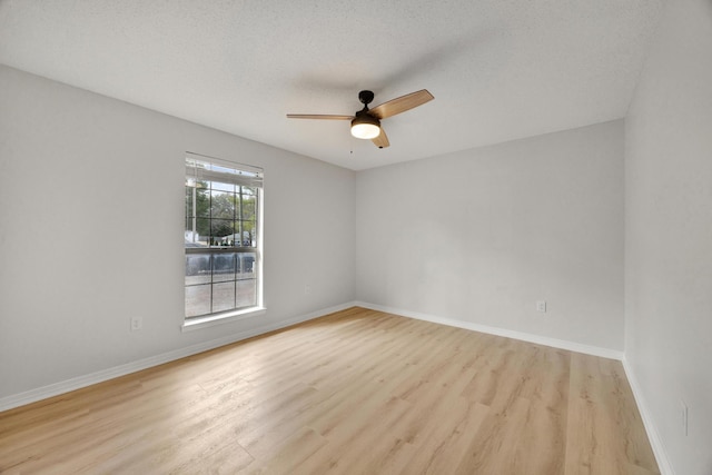 empty room featuring ceiling fan, light hardwood / wood-style floors, and a textured ceiling