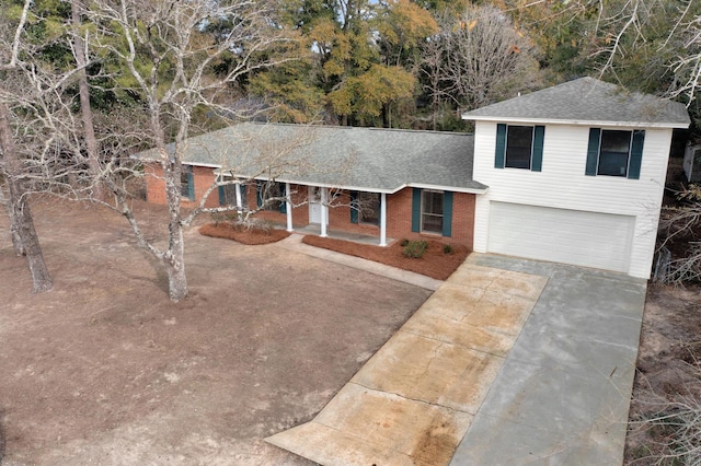 split level home featuring a garage and a porch