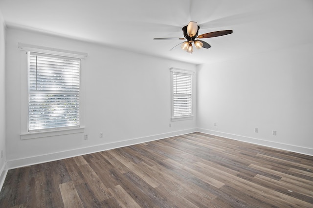 spare room featuring dark hardwood / wood-style floors and ceiling fan