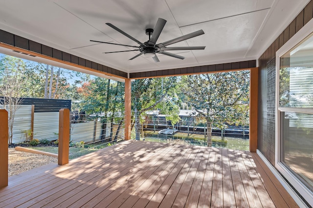 wooden deck featuring ceiling fan and a water view