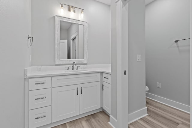 bathroom featuring hardwood / wood-style floors and vanity