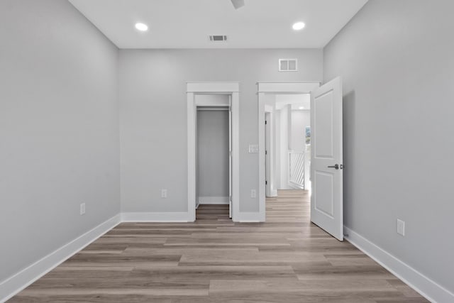 unfurnished bedroom featuring light wood-type flooring and a closet