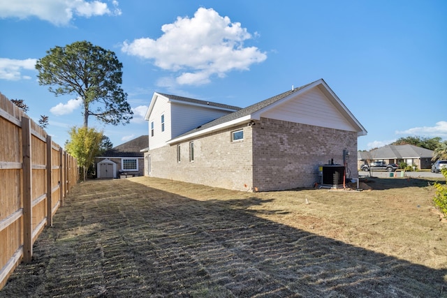 view of home's exterior with a storage unit and central AC