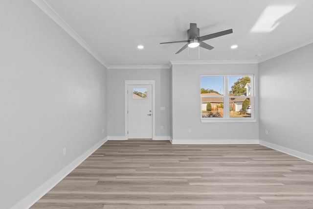 entryway with crown molding, ceiling fan, and light hardwood / wood-style floors