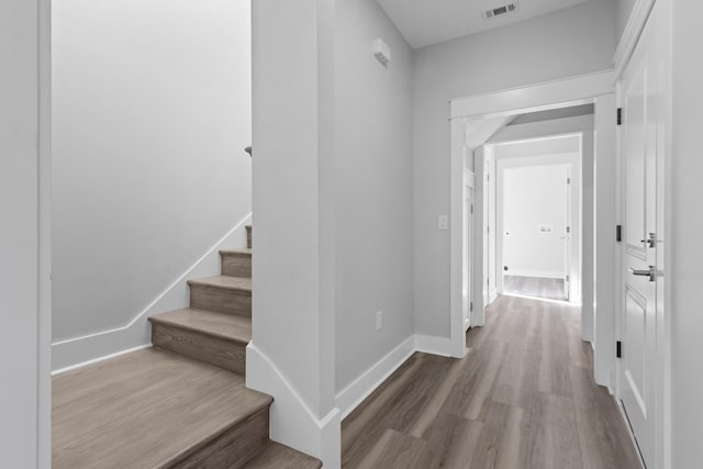 corridor with wood-type flooring