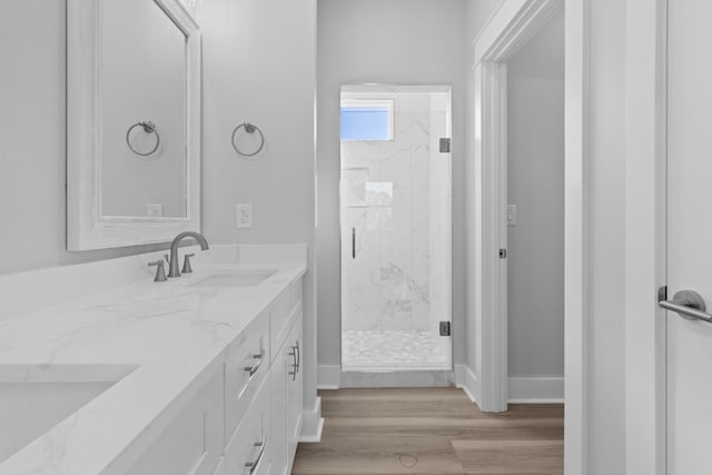 bathroom with vanity, wood-type flooring, and walk in shower