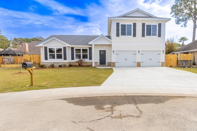 view of front of home with a garage, driveway, a front yard, and fence