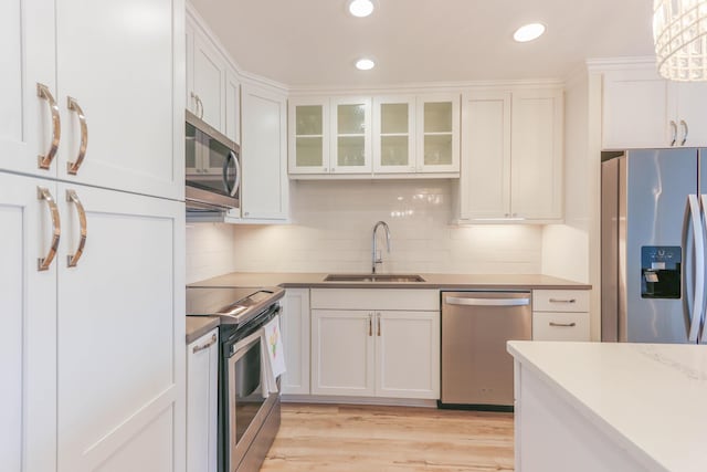 kitchen featuring white cabinets, sink, and stainless steel appliances