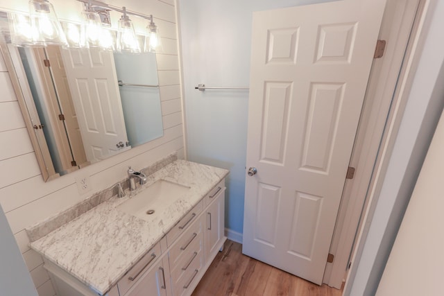 bathroom with hardwood / wood-style floors and vanity