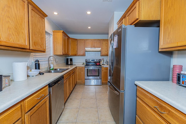 kitchen with sink, stainless steel appliances, and light tile patterned flooring