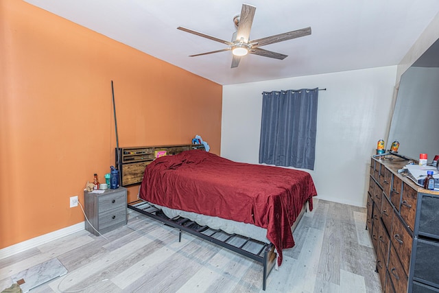 bedroom featuring ceiling fan and light hardwood / wood-style flooring