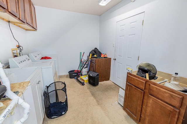 washroom with cabinets and washing machine and dryer