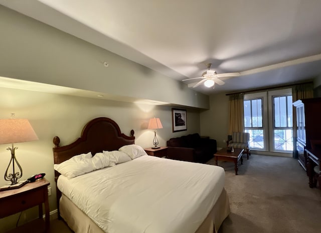 bedroom featuring ceiling fan and dark carpet