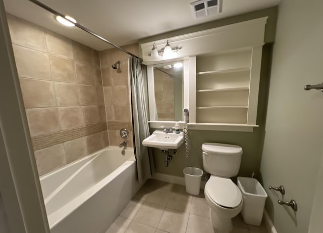 full bathroom featuring tile patterned floors, shower / bath combination with curtain, toilet, and sink