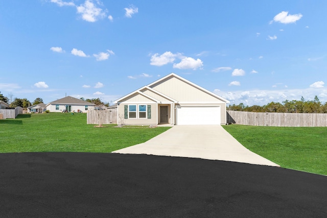 view of front of property with a front yard and a garage