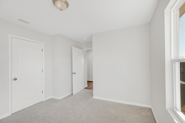 unfurnished bedroom with light colored carpet