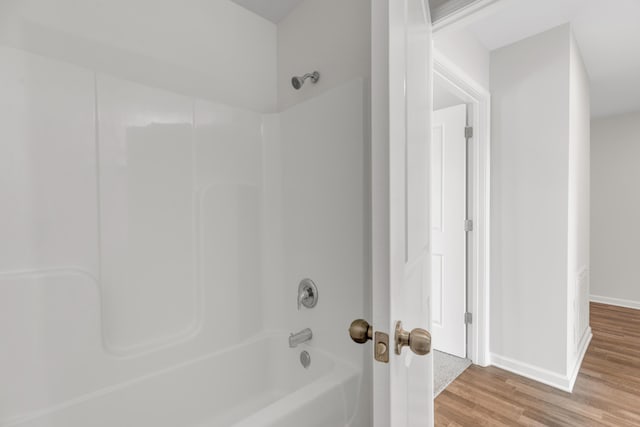 bathroom featuring shower / tub combination and hardwood / wood-style flooring