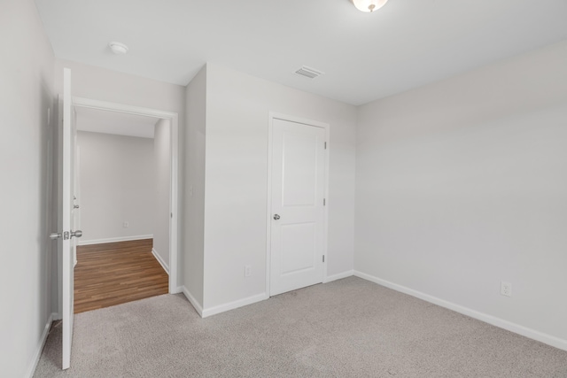 unfurnished bedroom featuring carpet flooring and a closet