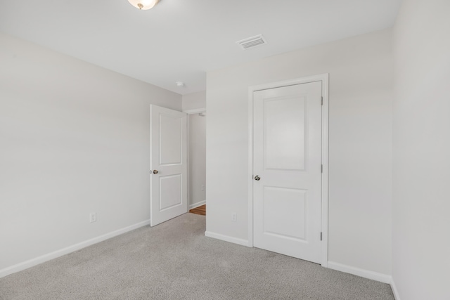 unfurnished bedroom featuring light colored carpet