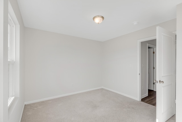 spare room featuring dark colored carpet