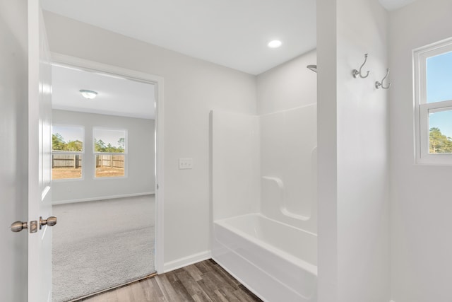 bathroom featuring hardwood / wood-style floors and bathtub / shower combination