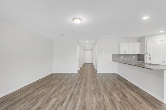 unfurnished living room featuring hardwood / wood-style flooring