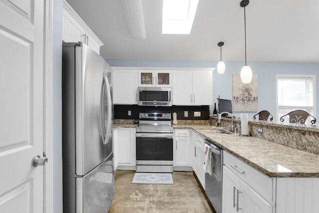 29 Santa Pine St, Santa Rosa Beach, FL 32459 - kitchen featuring a skylight, white cabinetry, sink, decorative light fixtures, and appliances with stainless steel finishes
