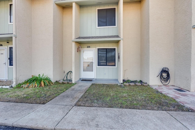 property entrance with a yard