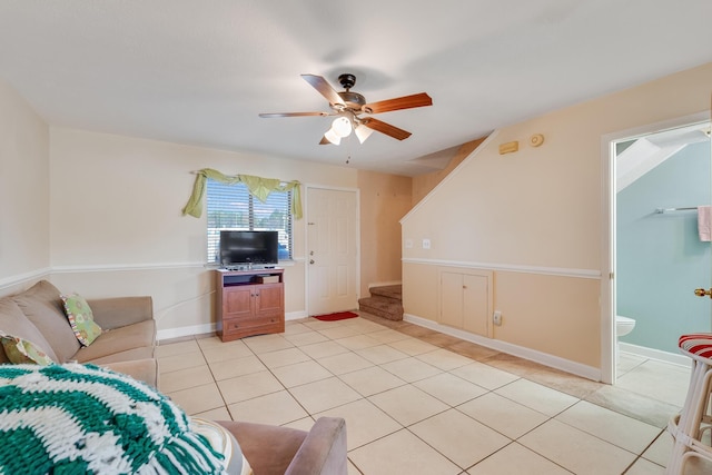 living room featuring light tile patterned floors and ceiling fan