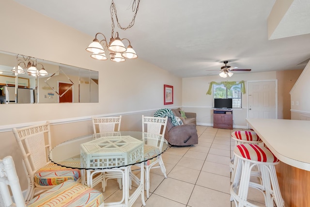 dining area with light tile patterned floors and ceiling fan with notable chandelier