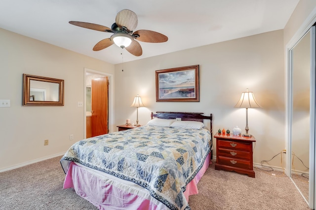 carpeted bedroom with ceiling fan and a closet